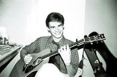 black and white photograph of man playing guitar