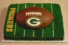 a football cake with green grass on top