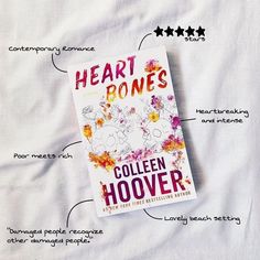 a book titled heart bones on top of a white sheet with flowers and stars around it