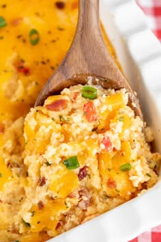 a casserole dish with a wooden spoon full of the casserole mixture