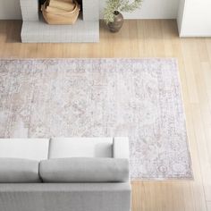 an overhead view of a living room with a couch, fireplace and large rug on the floor