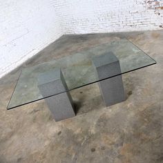 a glass table sitting on top of a cement floor