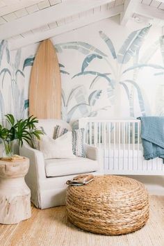 a living room with a surfboard on the wall next to a white crib