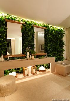 the bathroom is decorated with greenery and mirrors