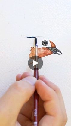 someone is drawing a bird on a piece of paper with crayon pencils