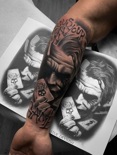 a man's arm with the joker tattoo on it