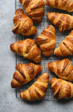 freshly baked croissants on a cooling rack