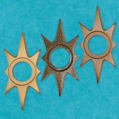 three different types of metal objects on a blue background, one has a ring and the other is a star