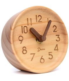 a small wooden clock with numbers on it