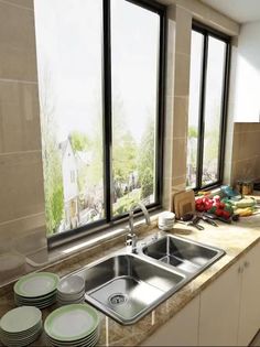 a kitchen counter with plates and bowls on it next to a window that looks out onto the street