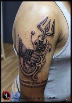 a man with a tattoo on his arm holding a knife and an arrow in it