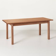 a wooden table sitting on top of a white floor