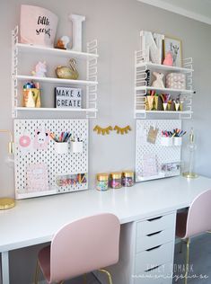 two desks with pink chairs and white shelving on the wall in a girls'room