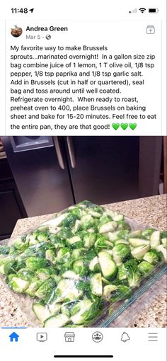 a glass dish filled with cucumbers sitting on top of a counter next to an oven