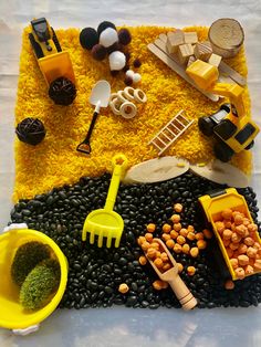 a table topped with lots of food on top of a white table covered in yellow and black stuff