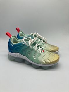 Elevate your sneaker game with these Nike Air VaporMax Plus in Mint Foam, Laser Blue, and Lime. The perfect addition to any women's athletic shoe collection, these sneakers are designed with a stylish and comfortable look in mind. Featuring the iconic Nike Air Vapormax Plus model, these shoes come in women's sizes 7.5-9.5 and are perfect for any occasion. The green colorway and sleek design make these shoes great for both casual and active wear. The brand's attention to detail and quality is evident in every aspect of the shoe, from the DQ7651-300 style code to the Nike Air VaporMax product line. Get ready to turn heads and feel amazing in these Nike Air VaporMax Plus sneakers. Athleisure Low-top Custom Sneakers With Air Max Cushioning, Custom Low-top Sneakers With Air Max Cushioning, Nike Sneakers With Air Max Cushioning For Light Sports, Nike Air Max Athleisure Custom Sneakers, Nike Air Max Athleisure Sneakers, Nike Custom Sneakers With Air Max Cushioning For Athleisure, Nike Sneakers With Air Cushioning, Nike Low-top Sneakers With Air Max Cushioning, Nike Air Max Low-top With Branded Insole