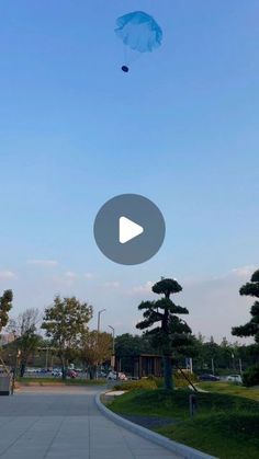 a kite flying in the sky over a park