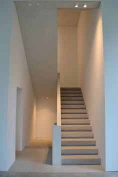 an empty room with stairs leading up to the second floor in arabic writing on it