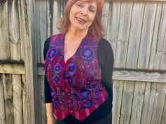 This 1990's women's vintage vest  is such a delightful piece! A v-neck button down style with a black satin back and a plum and pink striped front. The front is covered with stunning floral embroidery in deep purples, blue, brown and black. It features lovely fabric covered buttons and is fully lined with adjusting straps on back. Excellent quality. Made in Guatemala. 51% cotton, 16% rayon, 33% acetate Size Medium. Measurements: Chest: 102 cm / 40 inches Length: 56 cm / 22 inches BUYING VINTAGE: While all care is taken to state any obvious faults, please note that when you buy a vintage or preloved item, they may show small signs of ageing, wear and/or repair. Visit my new website   https://phoenixmenswear.com.au/ Lots of fun stuff for guys and girls...!! Please note that if you are orderi Retro V-neck Fitted Vest, Casual Fitted Purple Vest, Fitted Casual Purple Vest, Fitted Vintage V-neck Vest, Purple Sleeveless Vest For Fall, Retro Fitted V-neck Vest, Fitted Pink Vest For Fall, Fitted V-neck Vintage Vest, Longline Denim Jacket