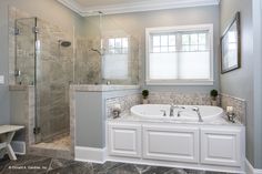 a bathroom with a large tub and walk in shower