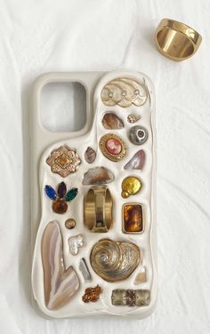 an iphone case with shells and other items on it