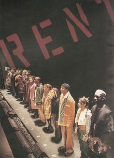 a group of people standing next to each other in front of a large ship with the word rein written on it