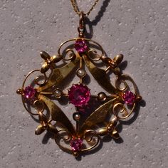 The 185th Street: Antique Seed Pearl And Vivid Pink Doublet Necklace. The Pendant Showcases A Vibrant Pink Doublet At Its Center, Accented By Seed Pearls Positioned In The Cardinal Directions. Below, A Polished Section Is Followed By Delicately Scrolled Filigree Adorned With A Floral Motif. The Pendant Is Further Embellished By Four Additional Vivid Pink Doublets. It Is Exquisitely Crafted In Yellow Gold And Features Serial Numbers On The Reverse Side For Authenticity. The Pendant Elegantly Hangs From A 17-Inch Italian-Made Chain Crafted In 14 Karat Yellow Gold. Prefer A Different Length Chain? We Can Shorten Or Extend The Chain For An Additional Fee Upon Request. Cardinal Directions, Accessory Inspo, Seed Pearl, Floral Motif, Seeds, Yellow Gold, Women Jewelry, Tea, Chain