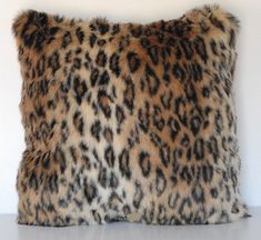 a leopard print pillow on a white surface