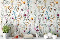 the wallpaper is decorated with colorful flowers and plants, along with two vases