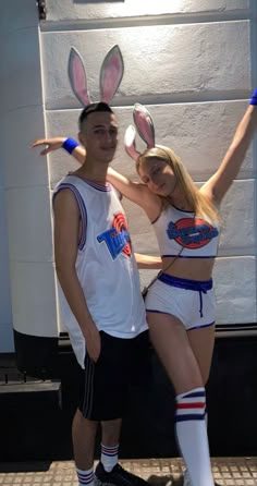 a man and woman dressed up in bunny ears