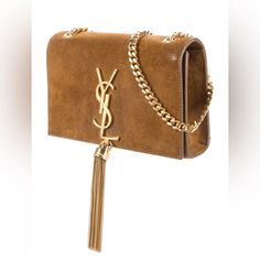 Yves Saint Laurent Crossbody Bag Brown Tan Suede Small From The 2016 Collection By Hedi Slimane Brown Suede Gold-Tone Hardware Chain-Link Shoulder Strap Tassel & Chain-Link Accents Leather Lining & Single Interior Pocket Snap Closure At Front Depth: 1.75" Width: 7.5" Shoulder Strap Drop: 22.75" Height: 4.75" Condition: Very Good. Minor Residue At Interior; Minor Scratches Throughout; Minor Balding At Front; Minor Scuffs At Corner; Minor Discoloration Throughout. Luxury Brown Shoulder Bag With Tassels, Elegant Suede Shoulder Bag With Gold-tone Hardware, Brown Suede-lined Crossbody Shoulder Bag, Brown Suede Bag With Gold-tone Hardware, Suede Crossbody Shoulder Bag With Gold-tone Hardware, Yves Saint Laurent Bags, Tassel Bag, Tan Suede, Brown Suede