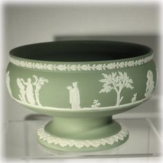 a green bowl with white designs on it