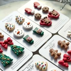 there are many different types of buttons on the table together, all decorated with bows and snowmen