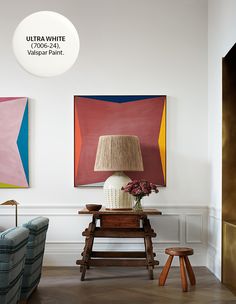 a living room with two paintings on the wall