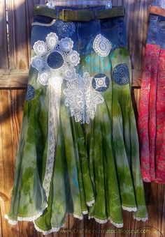 two women's skirts with flowers on them are hanging from a clothes line in front of a wooden door