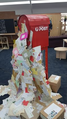 a mailbox that has been covered in many different types of letters and papers all over it