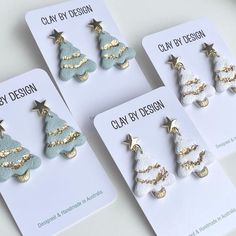 four pairs of christmas tree earrings on cards