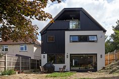 a large house with a black roof and white walls