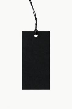 an empty black tag hanging from a string