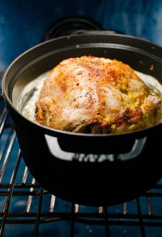 a cooked chicken in a skillet on an oven rack