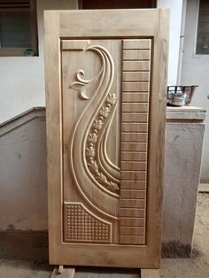 a carved wooden door in the shape of a letter s