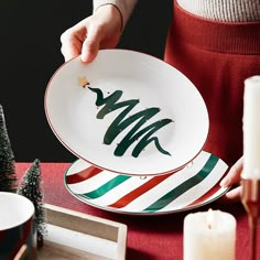 a person holding a plate with a christmas tree on it