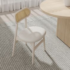 a white chair sitting in front of a wooden table