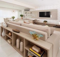 a living room filled with furniture and a flat screen tv mounted to the side of a wall