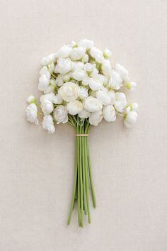 a bouquet of white flowers sitting on top of a table