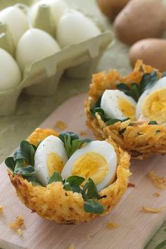 two eggs in a nest on a cutting board next to egg shells and other food items