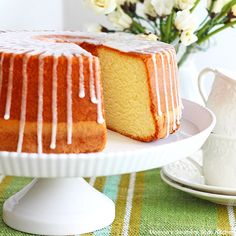 a bundt cake with icing sitting on a plate