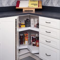 an open cabinet in the corner of a kitchen