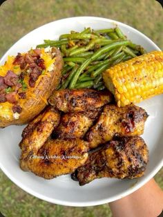 a plate with chicken, green beans and corn on the cob