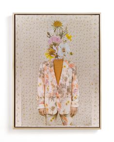 a man with flowers on his head is standing in front of a floral wallpaper